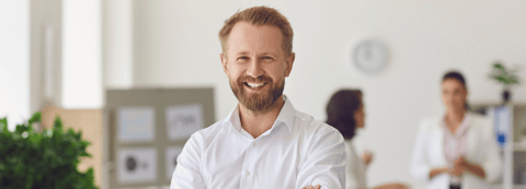 man in an office smiling